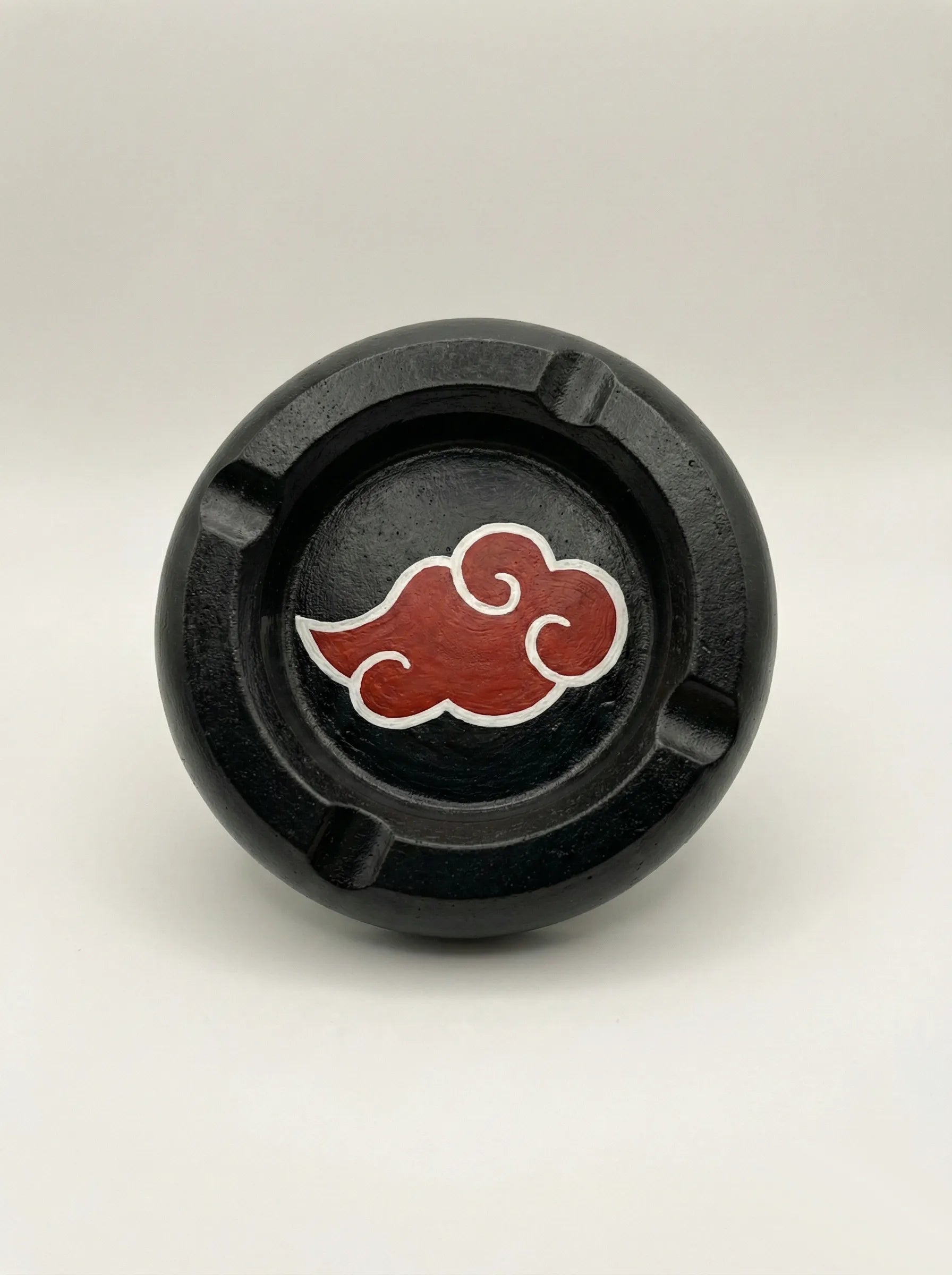 Black circular Akatsuki Ashtray with a red cloud symbol on a white background