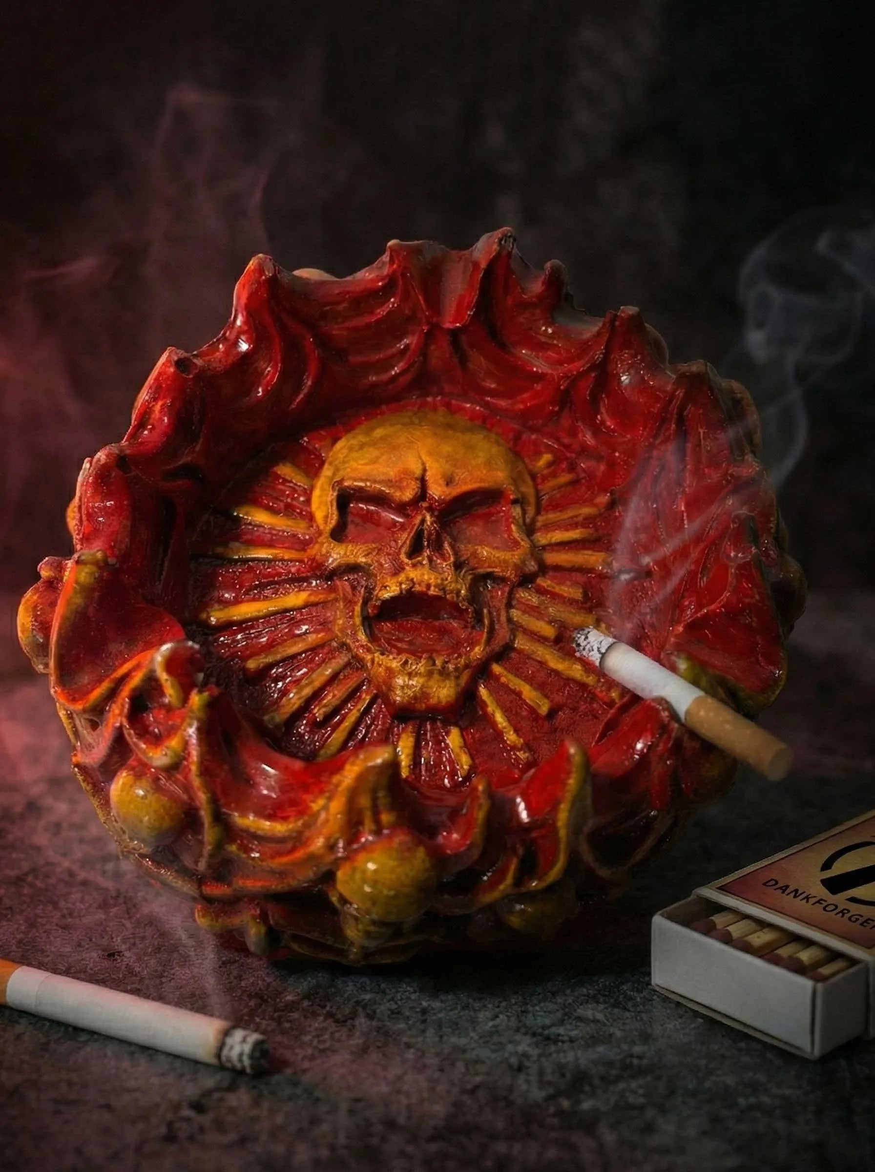 Designer ashtray with skull design and smoking accessories on a dark background