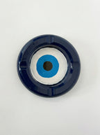 Round blue and white ashtray with a central black dot on a light gray background
