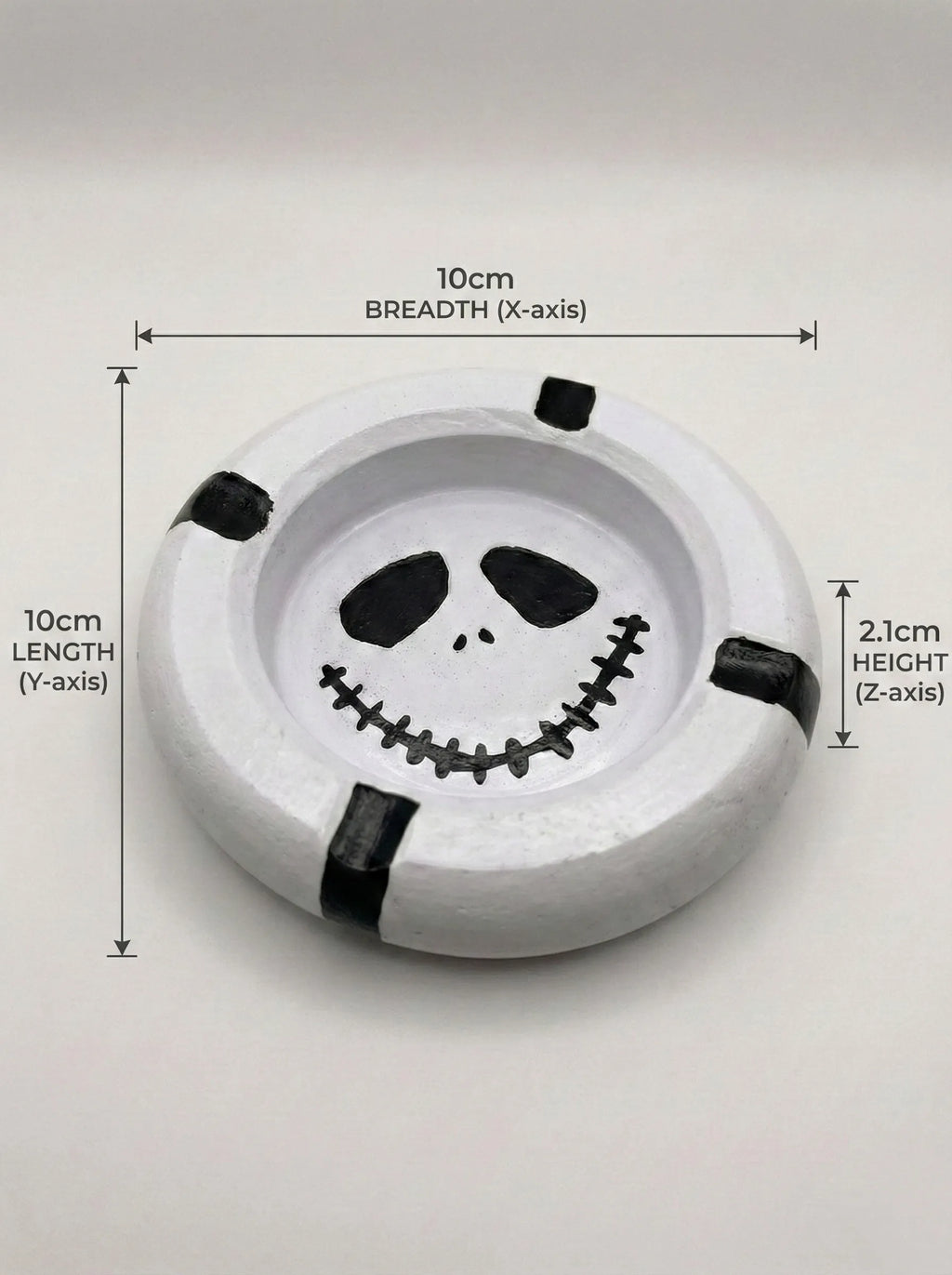 Circular ashtray with a mime face design and measurements on a white background