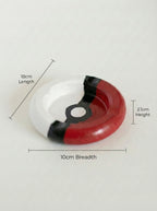 Pokeball-shaped ashtray with measurements on a white background