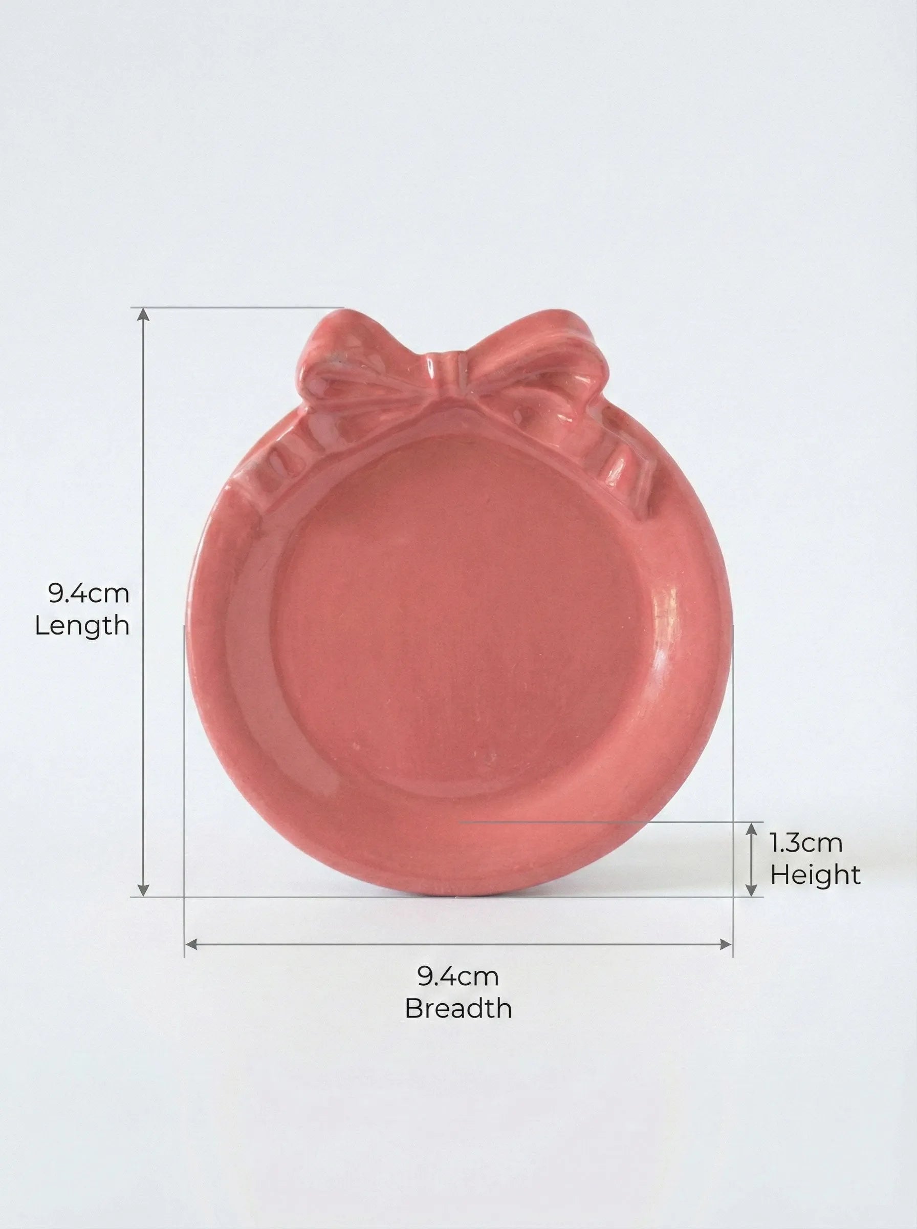 Pink Pookie plate concrete ashtray with a bow design and measurements on a white background