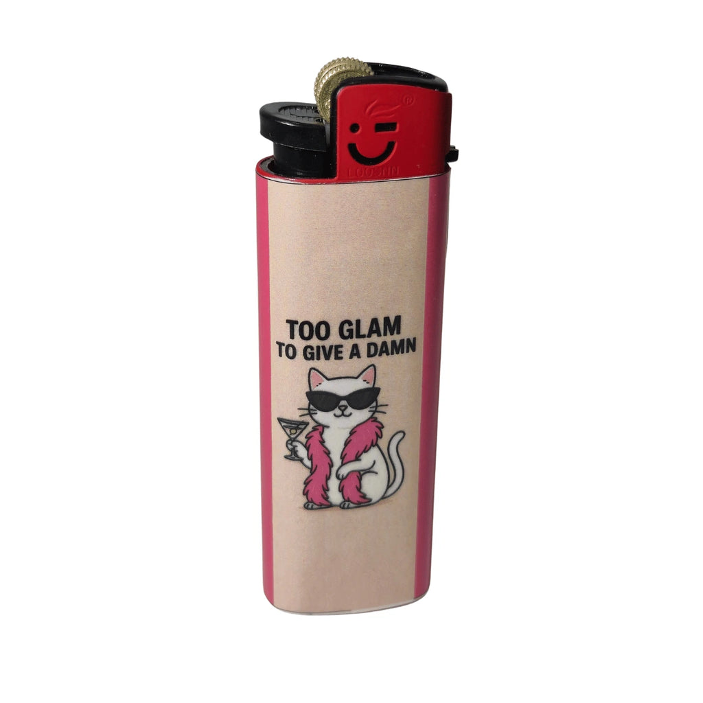 Too Glam flint wheel designer cigarette lighter for women with unique design and refillable pocket design
 lighter with a beige body, pink side borders, and a cartoon cat wearing sunglasses and holding a martini glass. The lighter has the text 'TOO GLAM TO GIVE A DAMN' printed on the front, with a red and black ignition mechanism at the top.