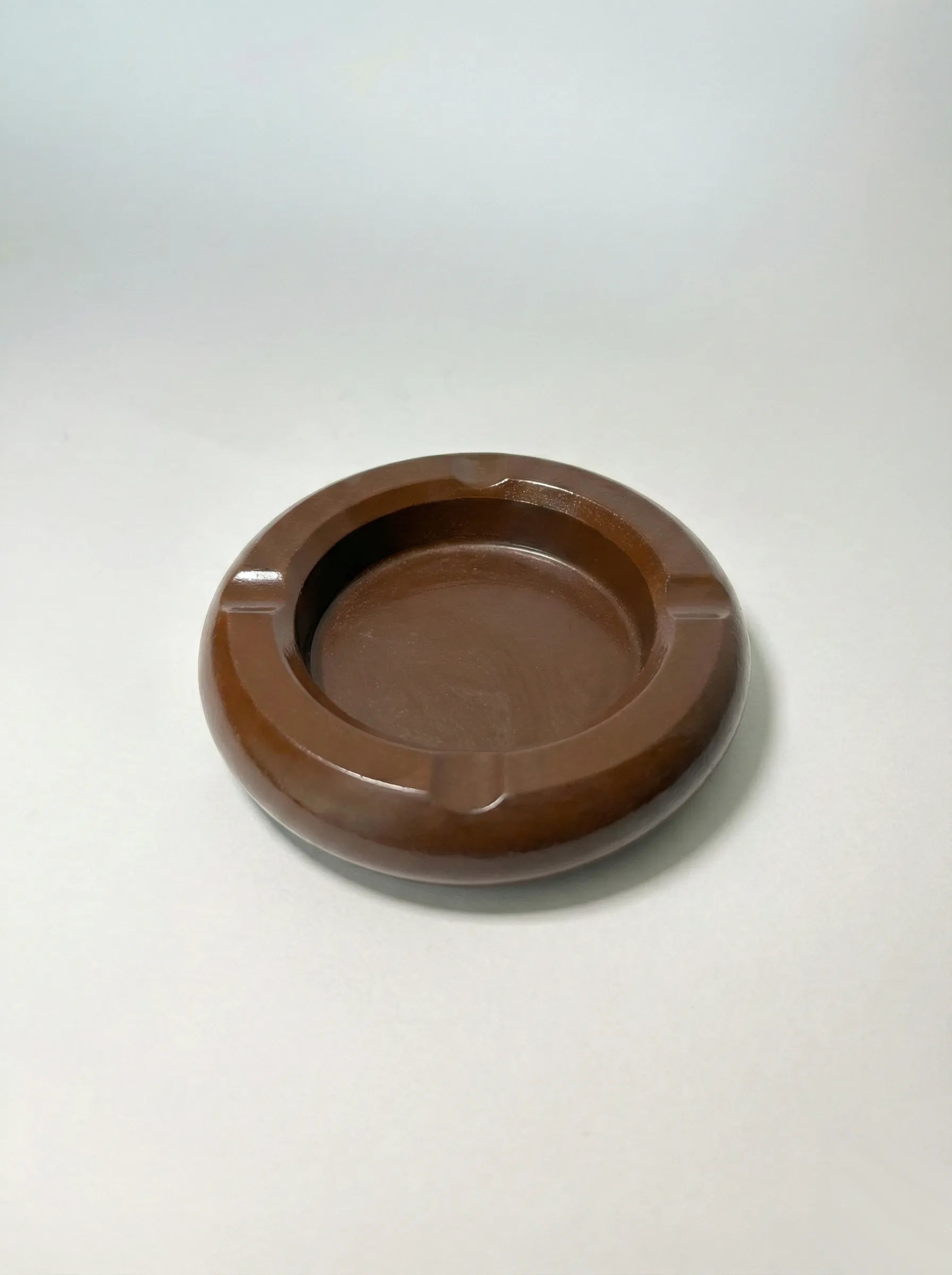 Umber Brown concrete ashtray on a white background