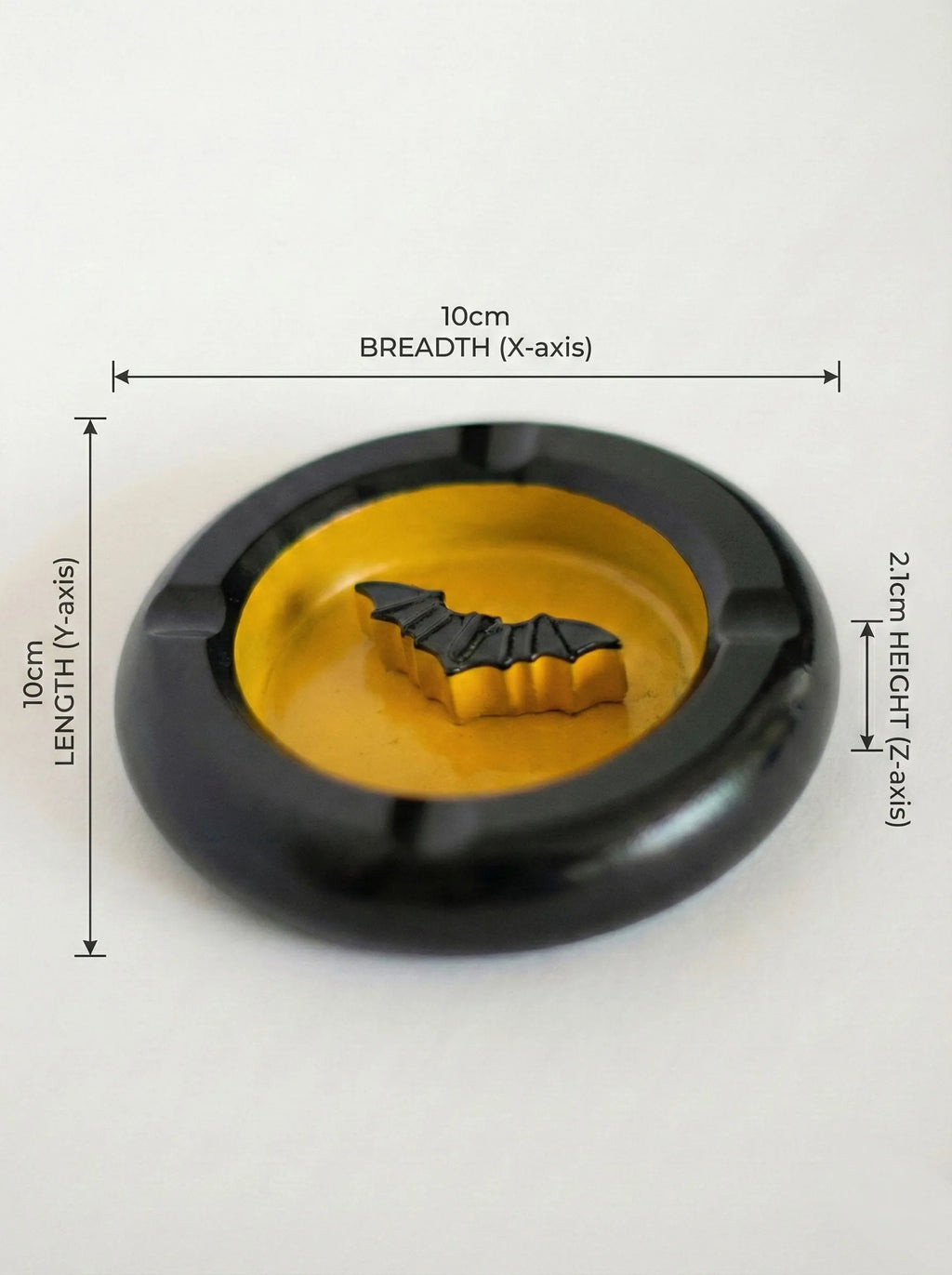 Black and yellow bat-man ashtray with bat design on a white background, showing measurements.